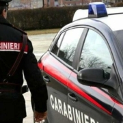 An Italian policeman by his car