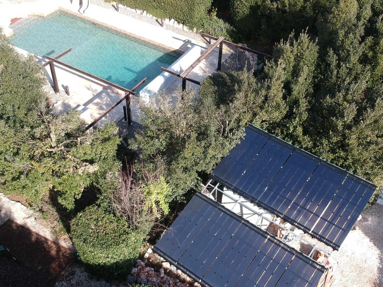 Solar pool heater tucked away out of sight behind the trees.